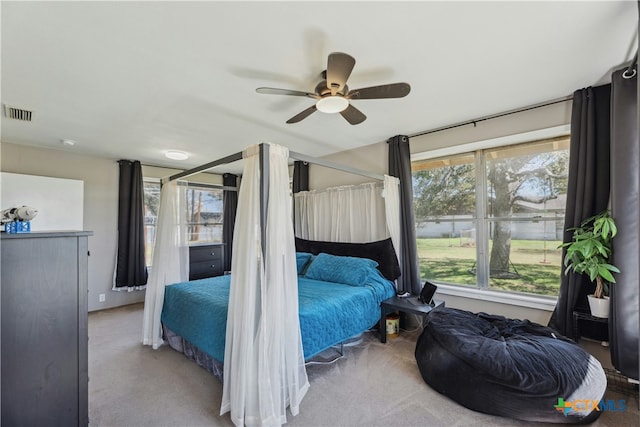 bedroom with carpet floors, ceiling fan, and visible vents