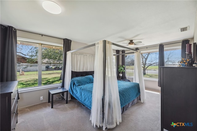 bedroom featuring carpet floors, a sunroom, and visible vents