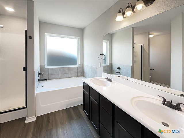 full bathroom featuring separate shower and tub, vanity, wood-type flooring, and toilet