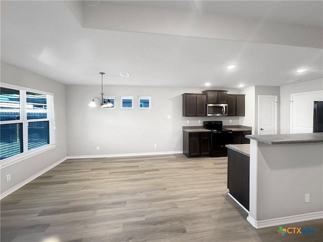 kitchen with black appliances, decorative light fixtures, light hardwood / wood-style flooring, a notable chandelier, and dark brown cabinets