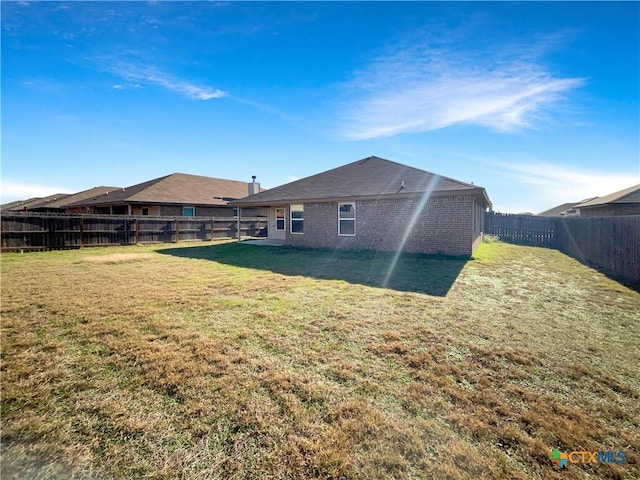 back of house with a lawn