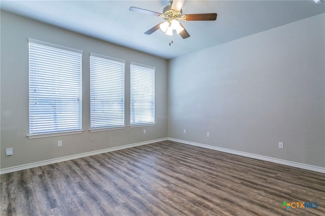 unfurnished room featuring ceiling fan and dark hardwood / wood-style floors