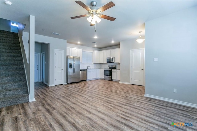 kitchen featuring backsplash, stainless steel appliances, ceiling fan, light hardwood / wood-style flooring, and white cabinetry