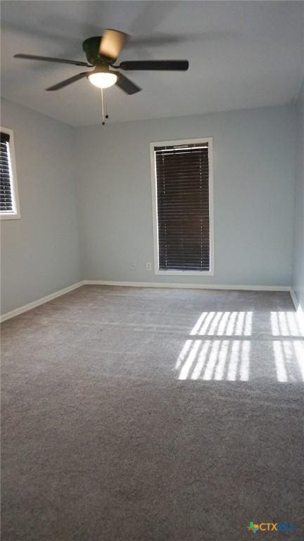 carpeted spare room featuring ceiling fan