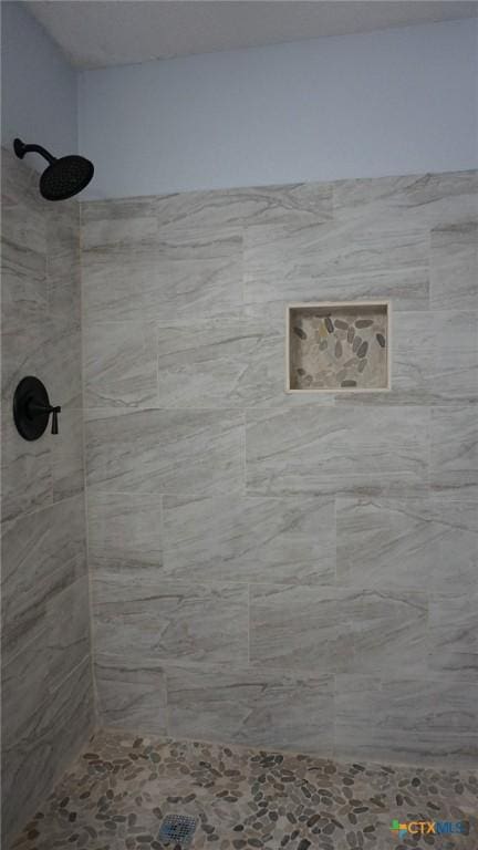 bathroom with a tile shower