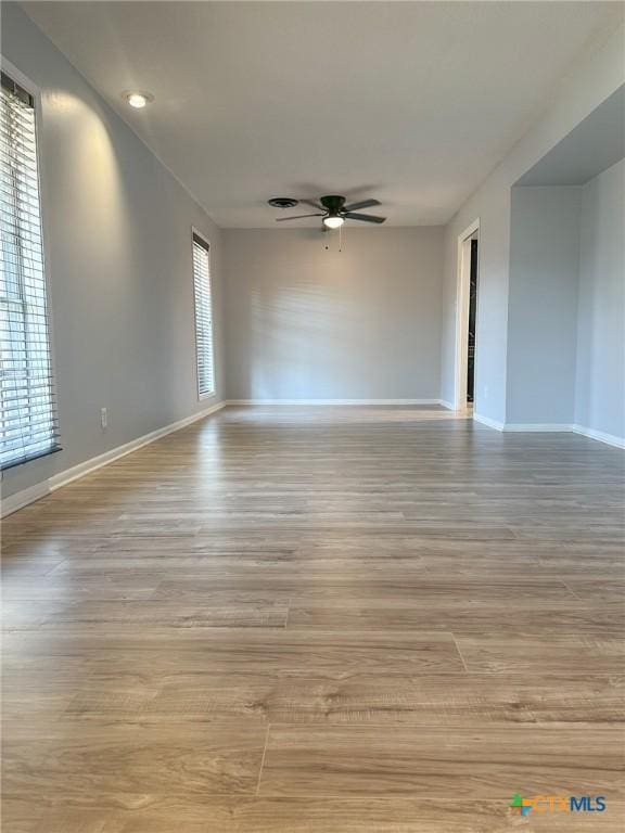 spare room featuring ceiling fan and light wood-type flooring