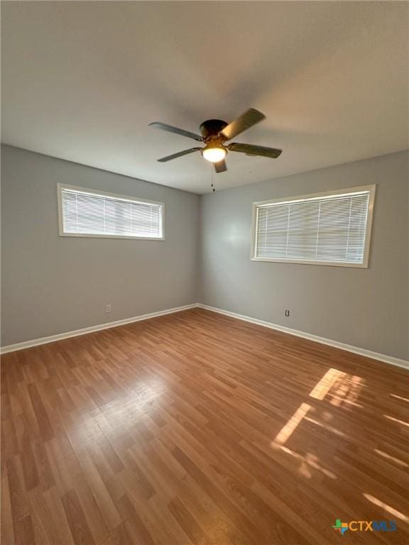 empty room with wood-type flooring and ceiling fan