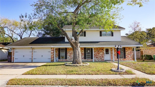 view of property with a porch, a garage, and a front yard