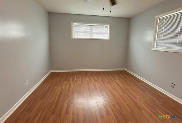 unfurnished room featuring ceiling fan and hardwood / wood-style floors