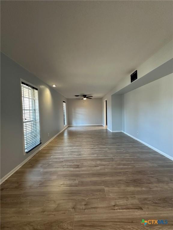 spare room with hardwood / wood-style flooring and ceiling fan