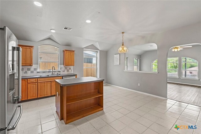 4504 Twin Oaks Cir, Killeen, TX 76542 - kitchen featuring stainless steel appliances, open shelves, a center island, tasteful backsplash, and light tile patterned floors
