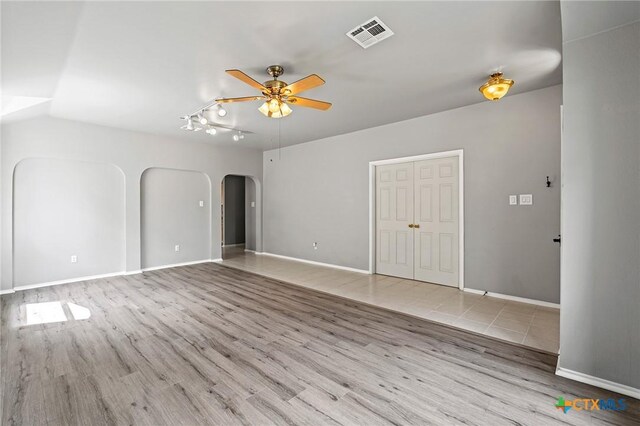 4504 Twin Oaks Cir, Killeen, TX 76542 - unfurnished living room featuring arched walkways, a ceiling fan, and wood finished floors