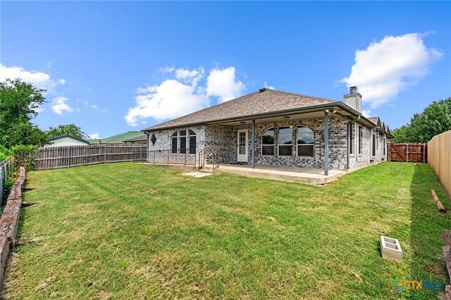 4504 Twin Oaks Cir, Killeen, TX 76542 - rear view of property with a patio, a fenced backyard, a chimney, and brick siding