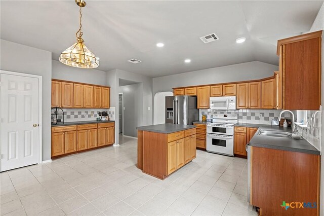 4504 Twin Oaks Cir, Killeen, TX 76542 - kitchen with white appliances, dark countertops, tasteful backsplash, a center island, and recessed lighting