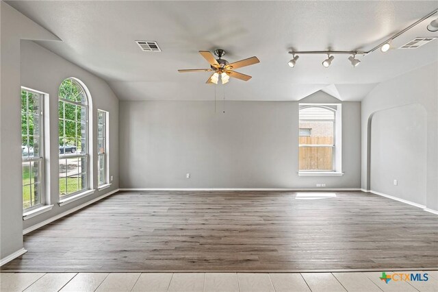 4504 Twin Oaks Cir, Killeen, TX 76542 - empty room featuring vaulted ceiling, a ceiling fan, and wood finished floors