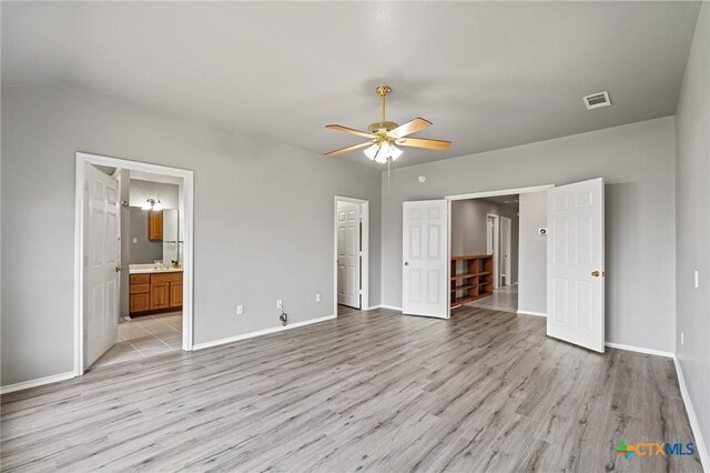 4504 Twin Oaks Cir, Killeen, TX 76542 - unfurnished bedroom with light wood-type flooring, ensuite bathroom, vaulted ceiling, and ceiling fan