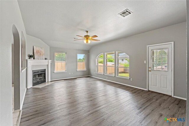 4504 Twin Oaks Cir, Killeen, TX 76542 - unfurnished living room with ceiling fan, wood finished floors, and a glass covered fireplace