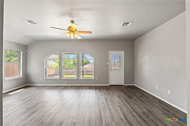 4504 Twin Oaks Cir, Killeen, TX 76542 - unfurnished living room featuring wood finished floors, a ceiling fan, and lofted ceiling