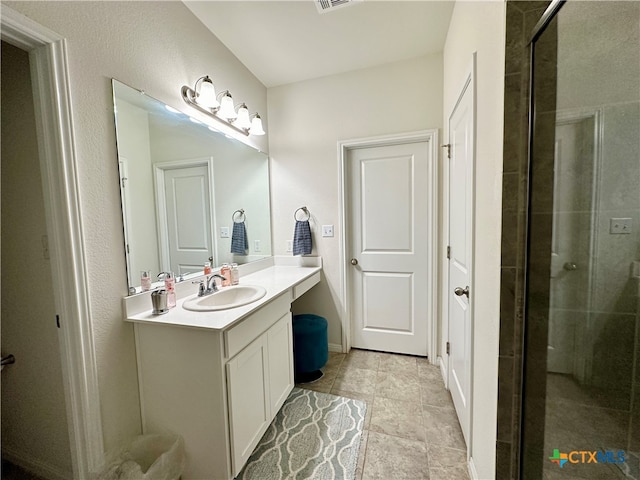 bathroom with a shower with door and vanity