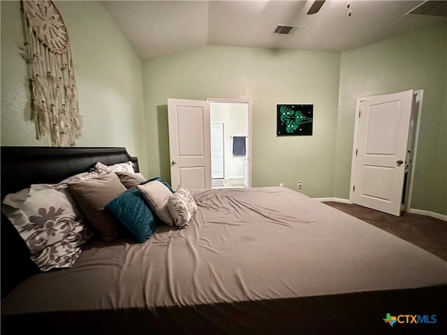 carpeted bedroom with ceiling fan and vaulted ceiling