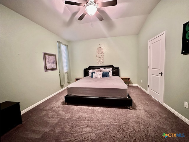 bedroom with vaulted ceiling, dark colored carpet, and ceiling fan