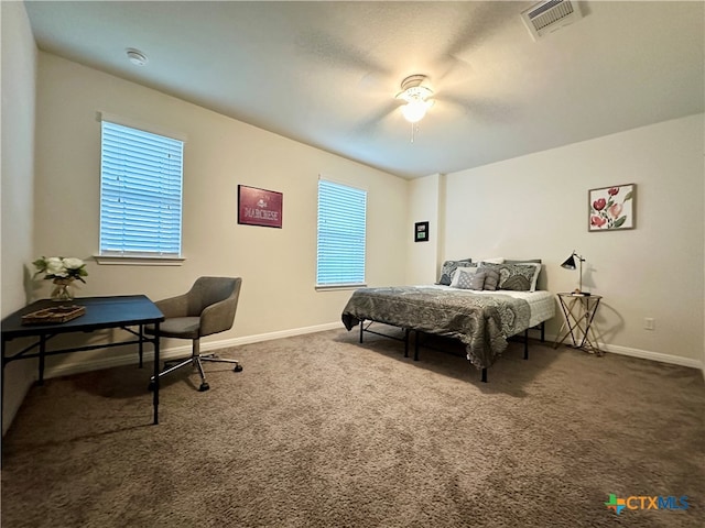 carpeted bedroom with multiple windows and ceiling fan