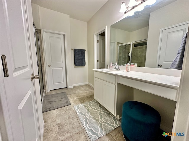 bathroom with a shower with shower door and vanity