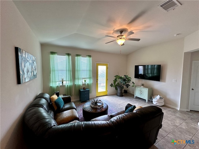 tiled living room with lofted ceiling and ceiling fan