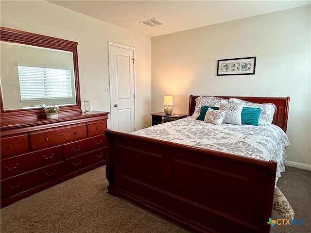 bedroom featuring dark carpet