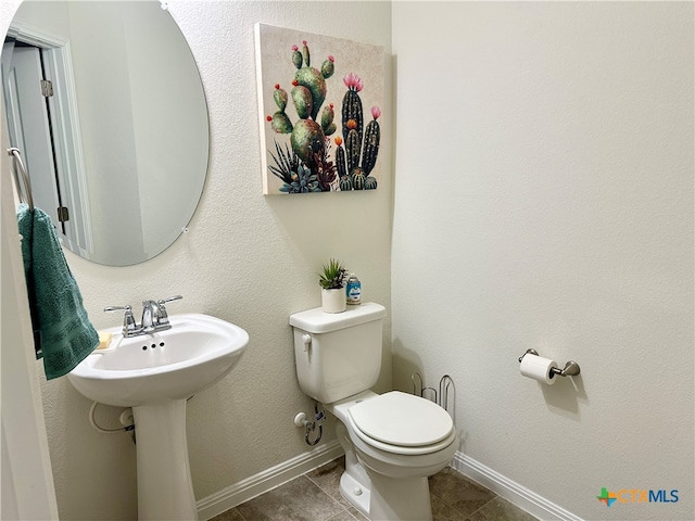 bathroom with tile patterned flooring and toilet