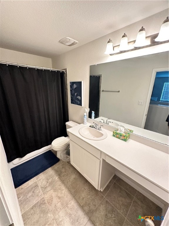 bathroom with vanity, a textured ceiling, and toilet