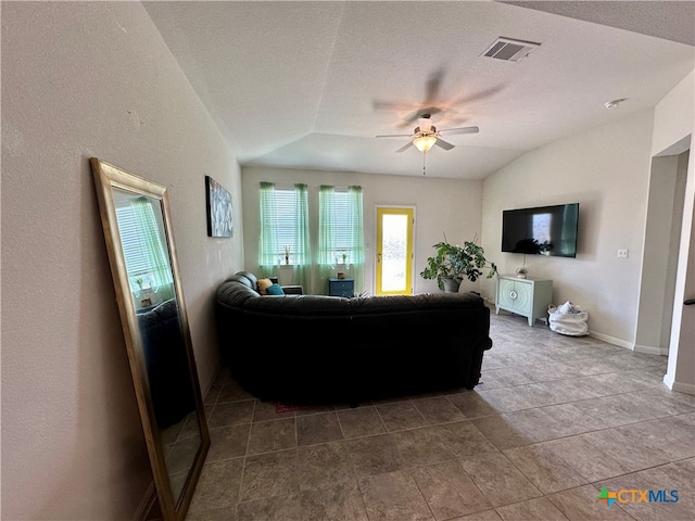 living room with ceiling fan, a textured ceiling, and lofted ceiling