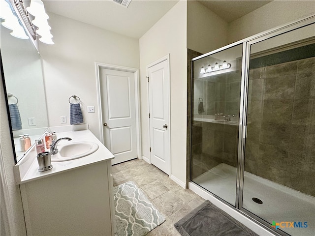 bathroom featuring an enclosed shower and vanity