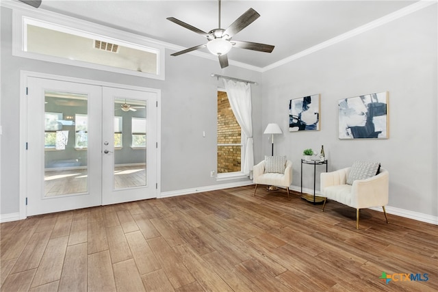 unfurnished room with hardwood / wood-style floors, ceiling fan, crown molding, and french doors