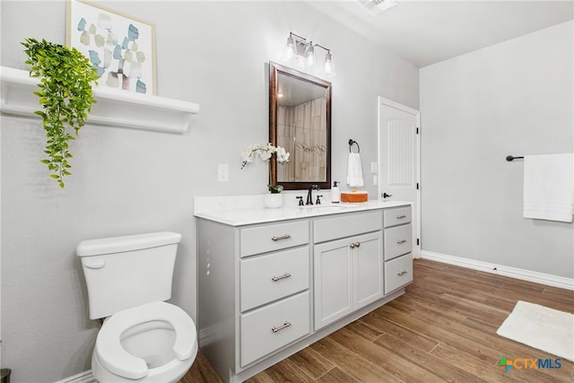 bathroom featuring hardwood / wood-style floors, vanity, and toilet