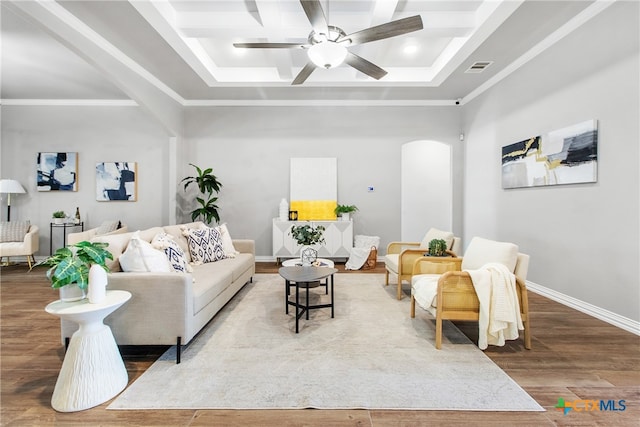 living room with hardwood / wood-style floors, ceiling fan, and a tray ceiling