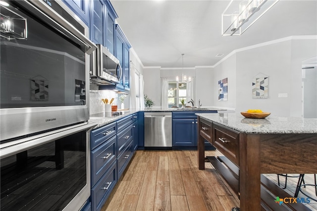 kitchen with blue cabinets, light hardwood / wood-style flooring, ornamental molding, appliances with stainless steel finishes, and light stone counters