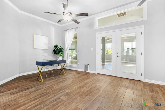 entryway with french doors, hardwood / wood-style flooring, ceiling fan, and crown molding