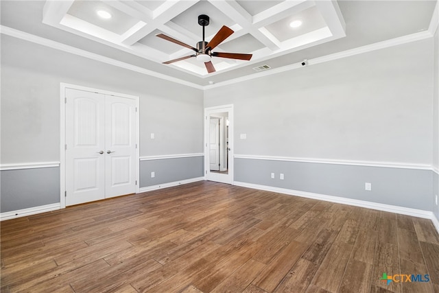 empty room with crown molding, beamed ceiling, wood-type flooring, and coffered ceiling