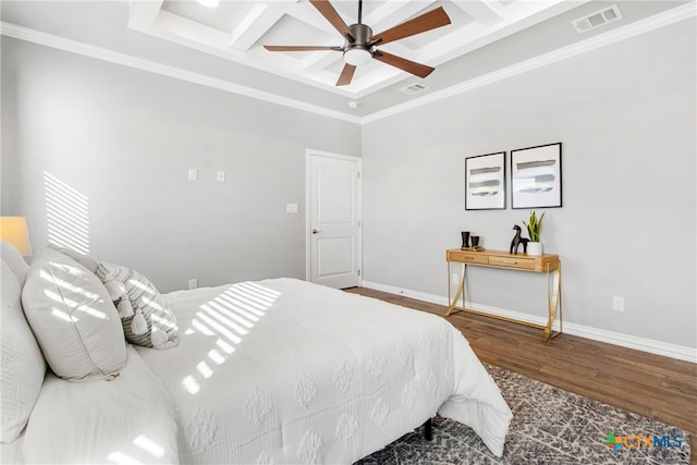 bedroom featuring ceiling fan, wood-type flooring, coffered ceiling, and ornamental molding