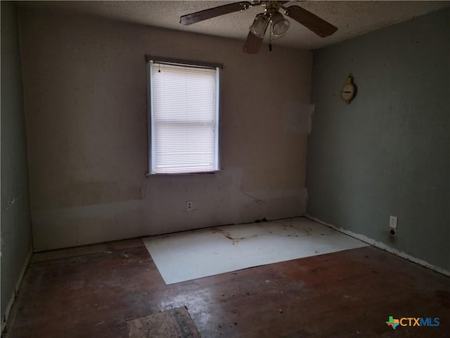 spare room with a textured ceiling and ceiling fan