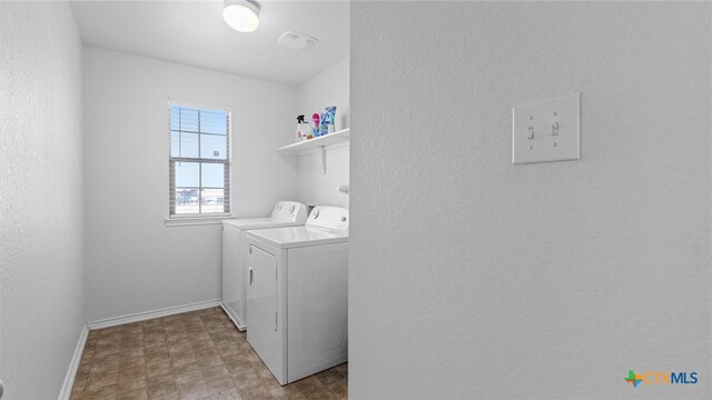 laundry room with washing machine and dryer