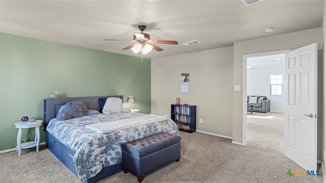 bedroom with ceiling fan and light colored carpet