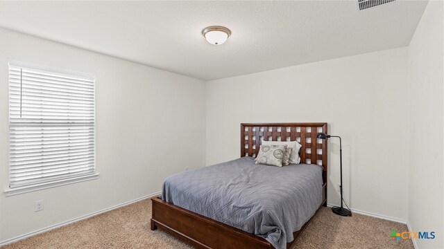 bedroom featuring light colored carpet