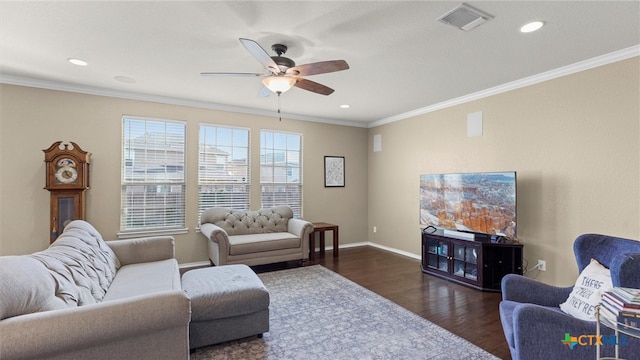 living room featuring dark hardwood / wood-style flooring, ceiling fan, and crown molding