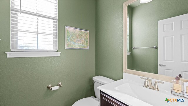 bathroom featuring vanity and toilet