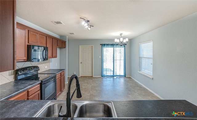 kitchen featuring black appliances, tasteful backsplash, a notable chandelier, hanging light fixtures, and sink