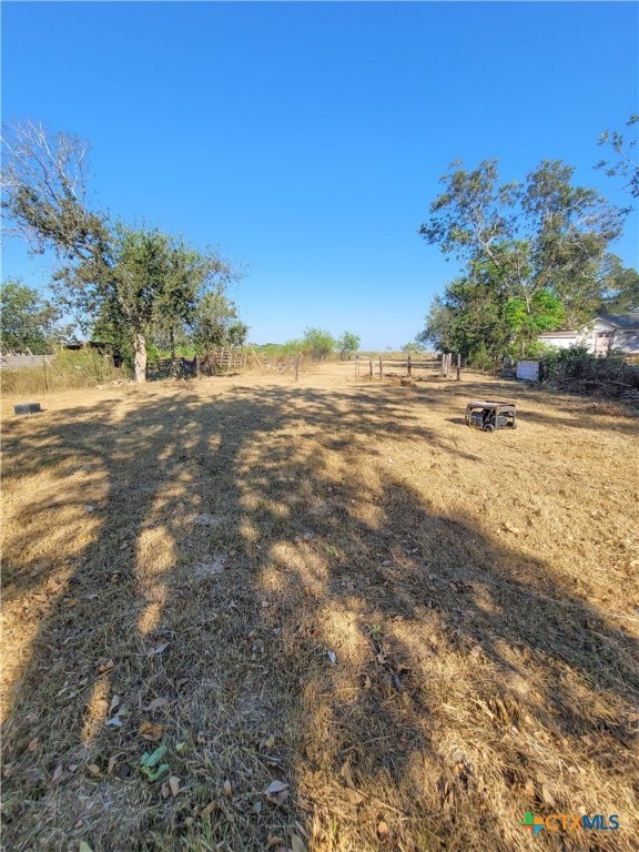 view of yard with a rural view