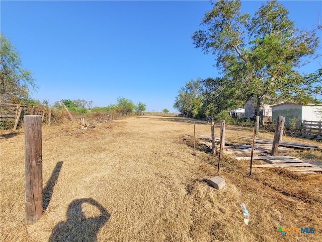 view of yard with a rural view