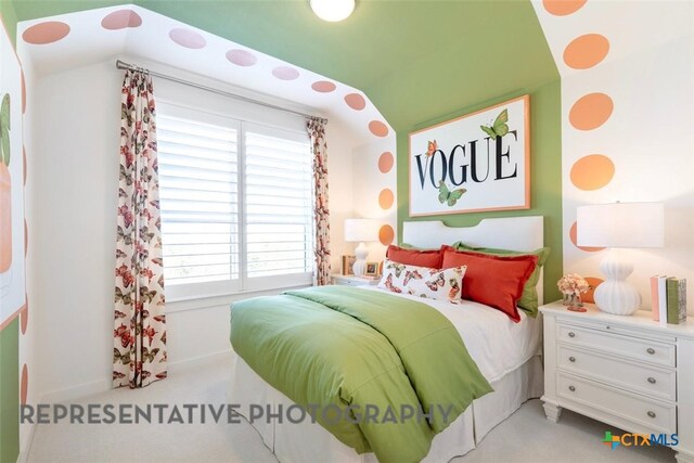 225 Dycus Bnd, Liberty Hill, TX 78642 - bedroom with multiple windows, lofted ceiling, and light colored carpet